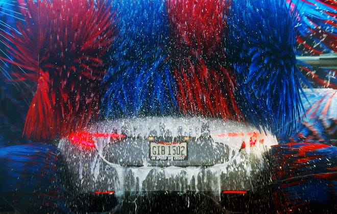 A motorist has their ride cleaned at the Splash Car Wash in Fairlawn,