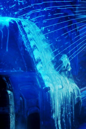 A truck is sprayed down with soap as it passes through the Splash Car Wash in Fairlawn.