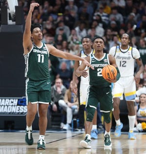 Michigan State Spartans guards A.J. Hoggard (11) and Tyson Walker (2) celebrate the 69-60 win against the Marquette Golden Eagles during the second round of the NCAA tournament in Columbus, Ohio, March 19, 2023.