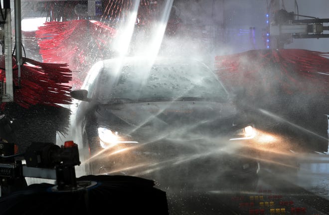 A car gets soap spray on it as it gets washed at Sgt. Clean Car Wash in Cuyahoga Falls.