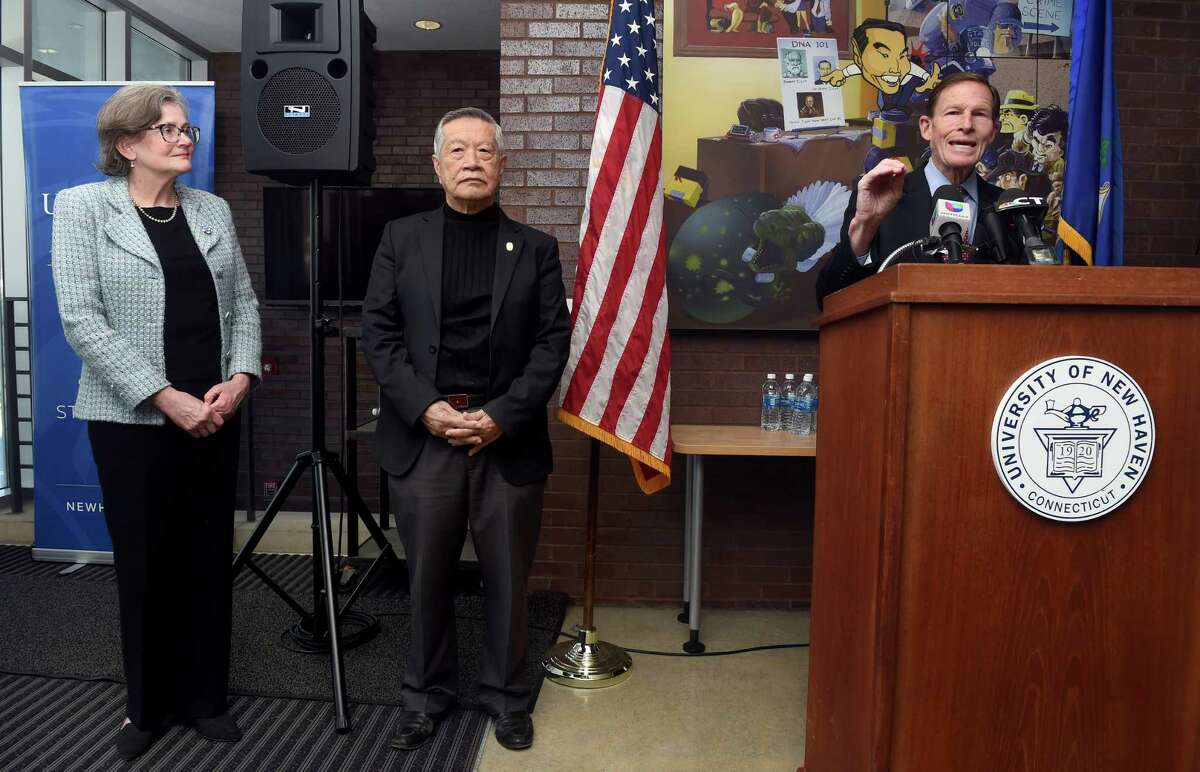 From left, Betsy Francis-Connolly, dean of the School of Health Sciences, and Henry C. Lee, founder of the Henry C. Lee Institute of Forensic Science, listen to U.S. Sen. Richard Blumenthal announce a $1 million federal grant for the University of New Haven's Henry C. Lee College of Criminal Justice and Forensic Sciences in West Haven for gun violence date analytics.