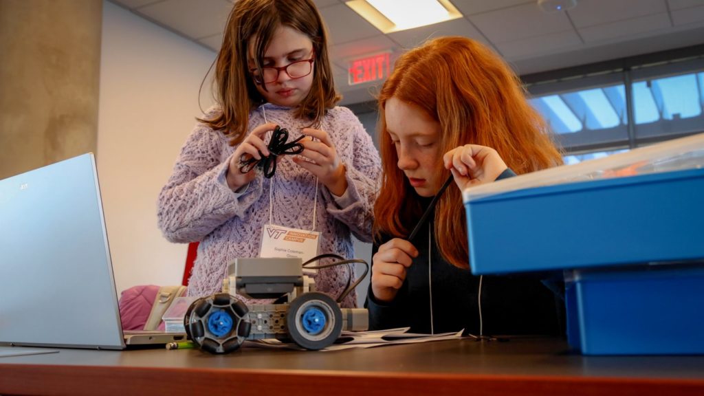 Middle school students build and program Vex IQ robots.