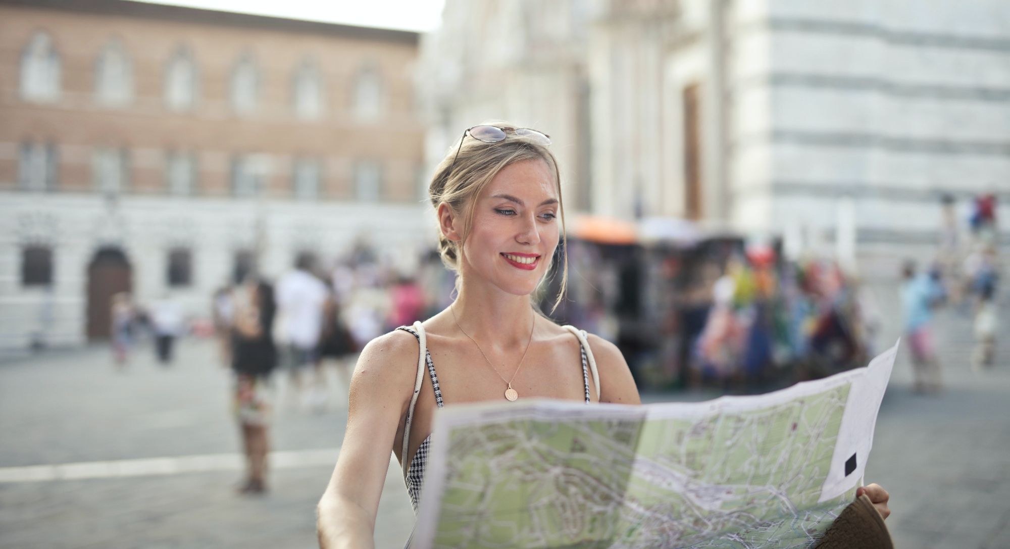 woman in city holding map